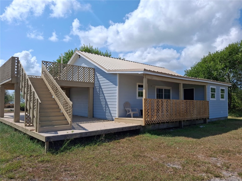 2001 1st Street Bayside, TX 78340 - Photo 1 of 26 a front view of a house with a garden