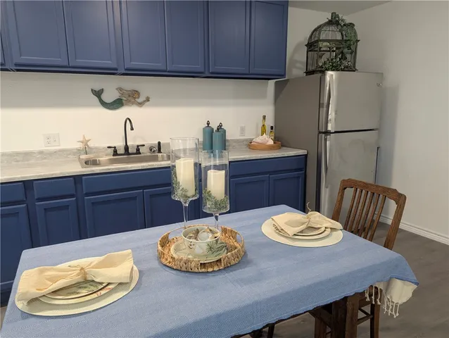 a kitchen with granite countertop a sink and wooden cabinets
