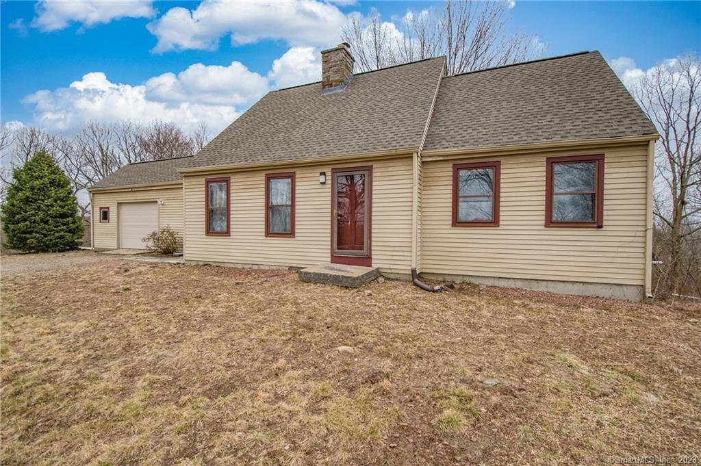 129 Mountain Spring Road Tolland, CT 06084 - Photo 1 of 1 a house with trees in the background