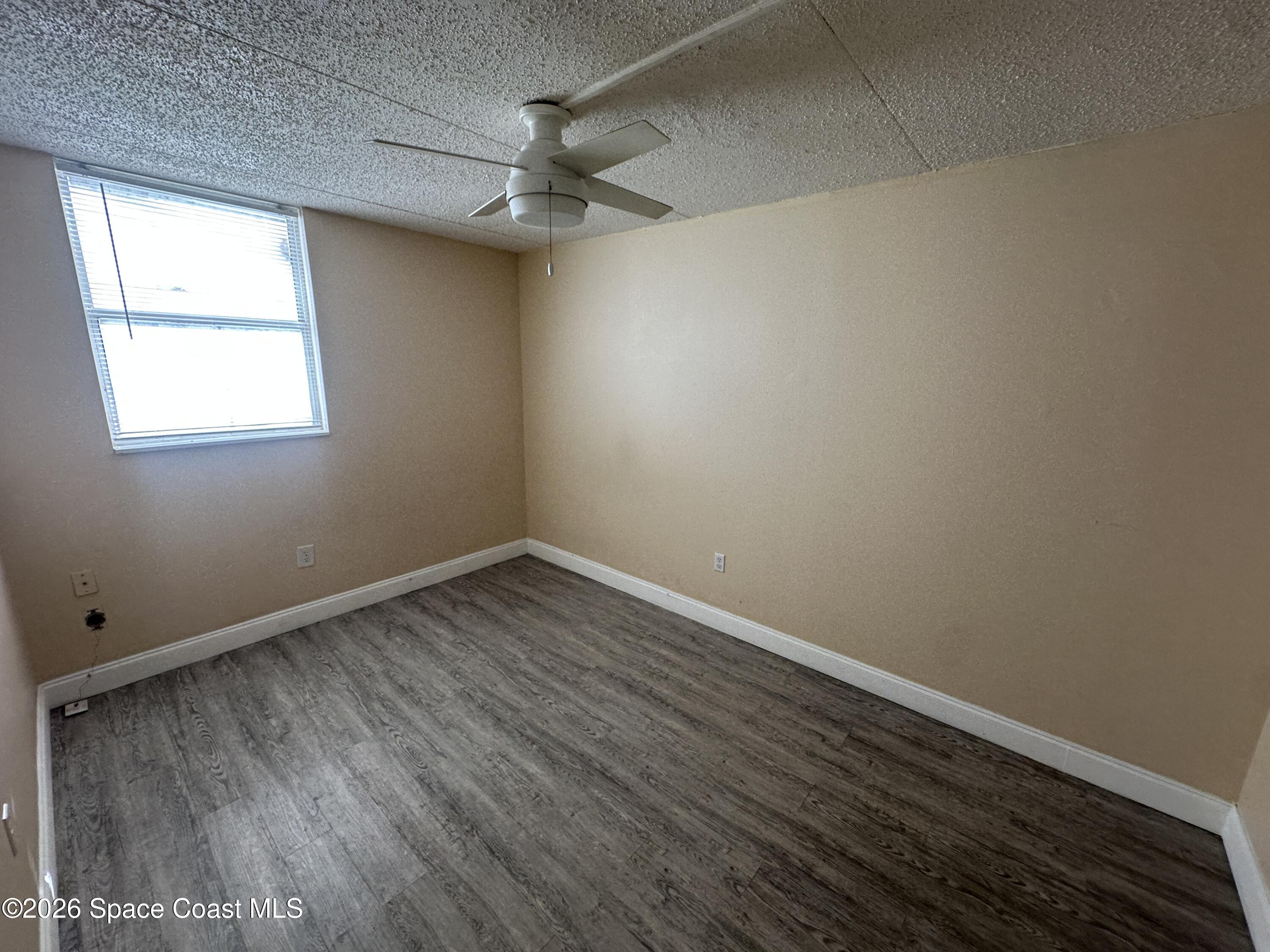 240 Stone Street, Unit 6 Cocoa, FL 32922 - Photo 6 of 7 an empty room with a window