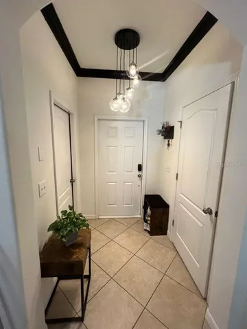 a front view of a house with a potted plant