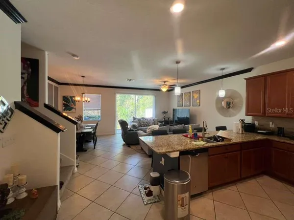 a kitchen with a sink and chairs