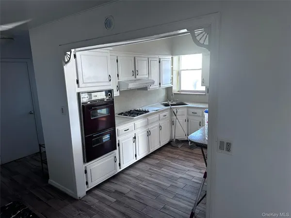 a kitchen with stainless steel appliances a white stove top oven and sink