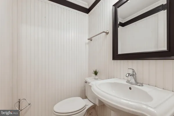 a bathroom with a sink a toilet and mirror