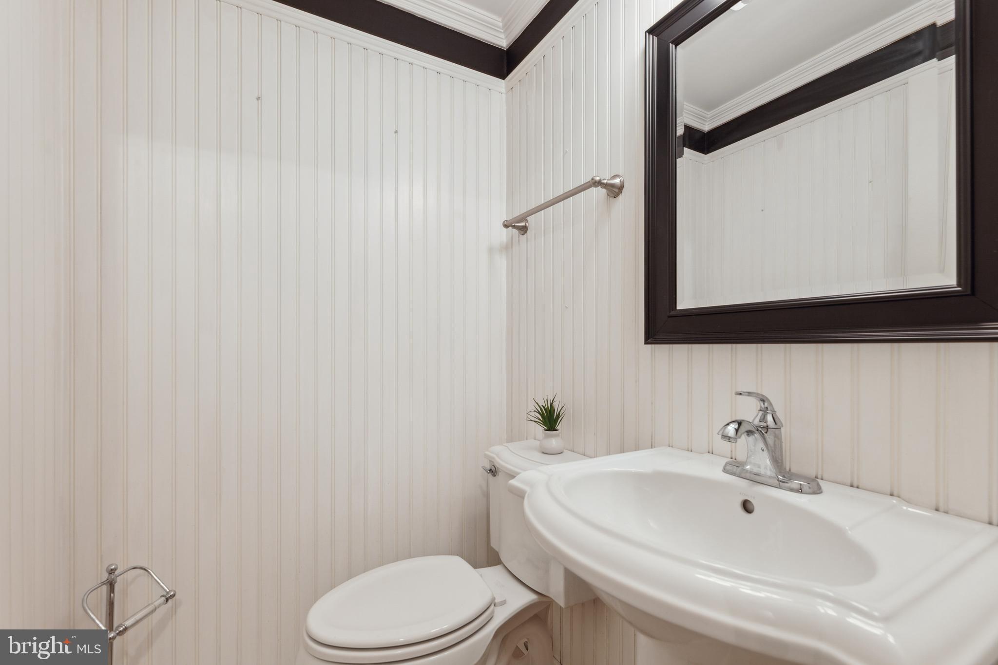 8112 Rhodell Lane Springfield, VA 22153 - Photo 14 of 15 a bathroom with a sink a toilet and mirror