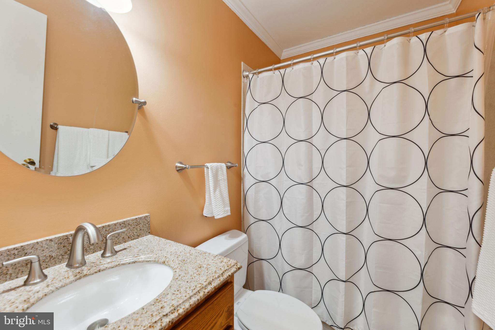 8112 Rhodell Lane Springfield, VA 22153 - Photo 15 of 15 a bathroom with a granite countertop sink and a mirror