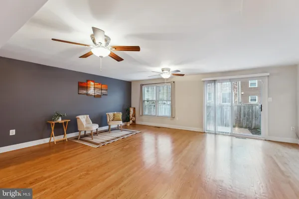 a living room with furniture and a ceiling fan