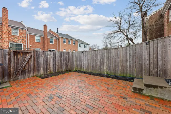 a backyard of a house with a bench