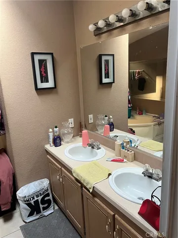 a bathroom with a sink mirror and vanity
