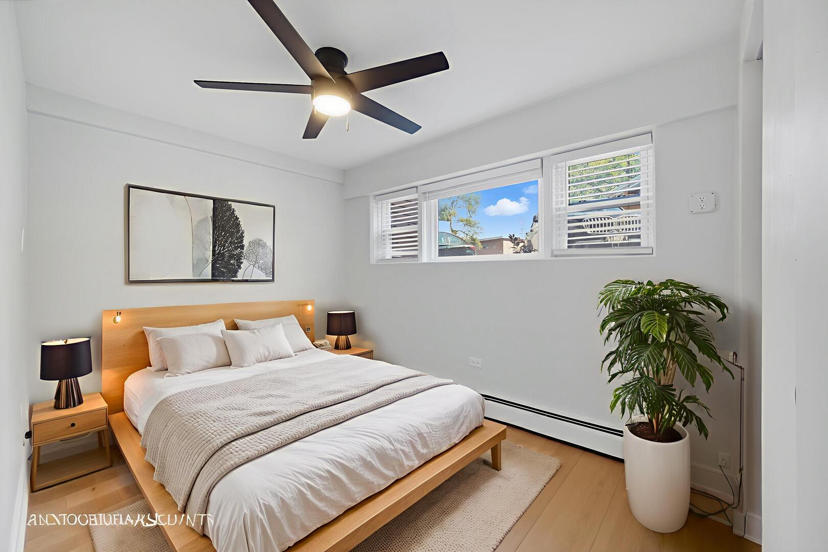 143 Ann Street, Unit 1S Clarendon Hills, IL 60514 - Photo 13 of 27 a bedroom with a bed and a potted plant