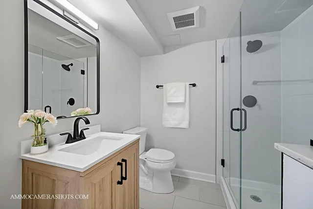 a bathroom with a sink toilet and shower