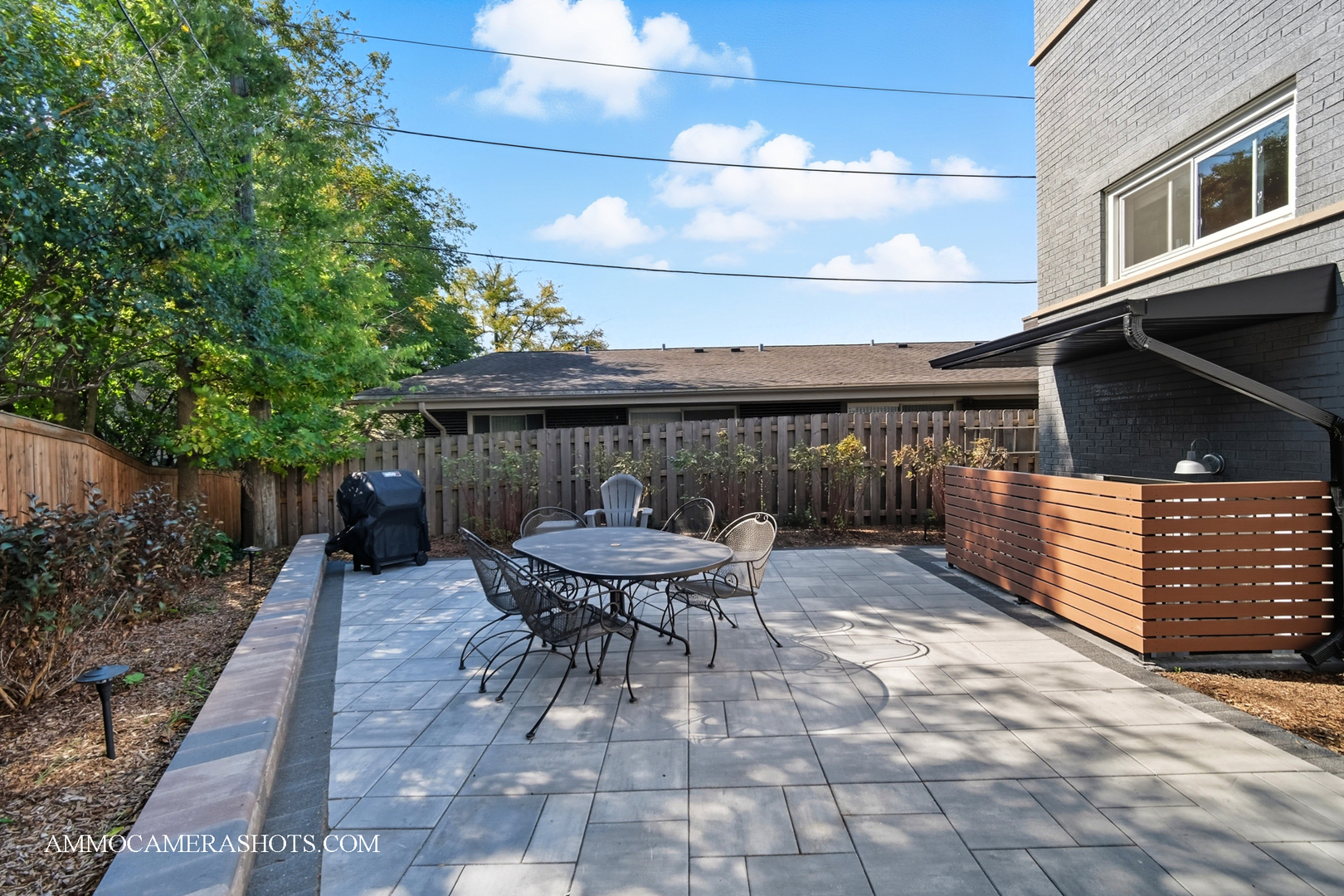 143 Ann Street, Unit 1S Clarendon Hills, IL 60514 - Photo 19 of 27 a view of a patio with table and chairs with wooden fence