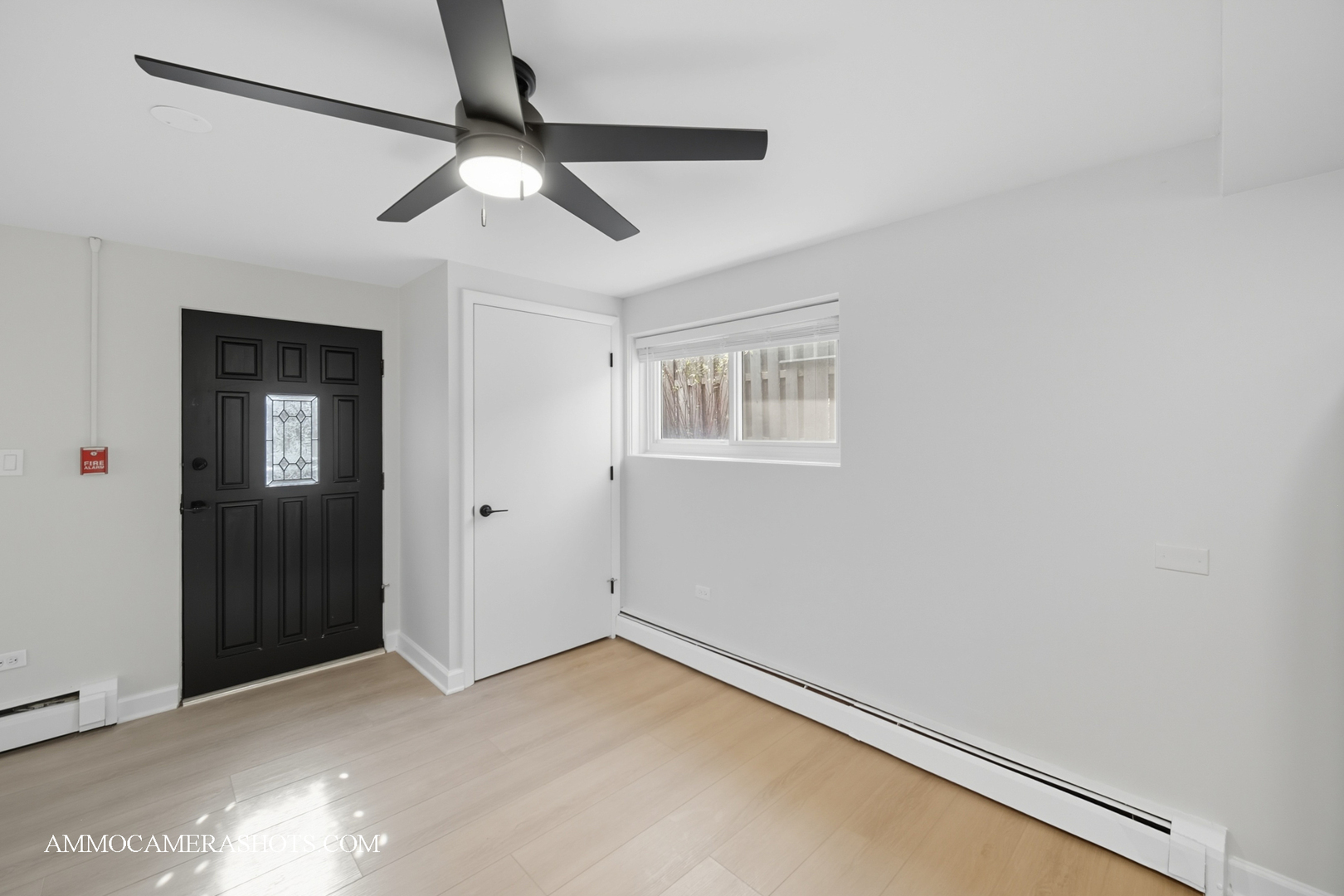 143 Ann Street, Unit 1S Clarendon Hills, IL 60514 - Photo 3 of 27 an empty room with chandelier fan