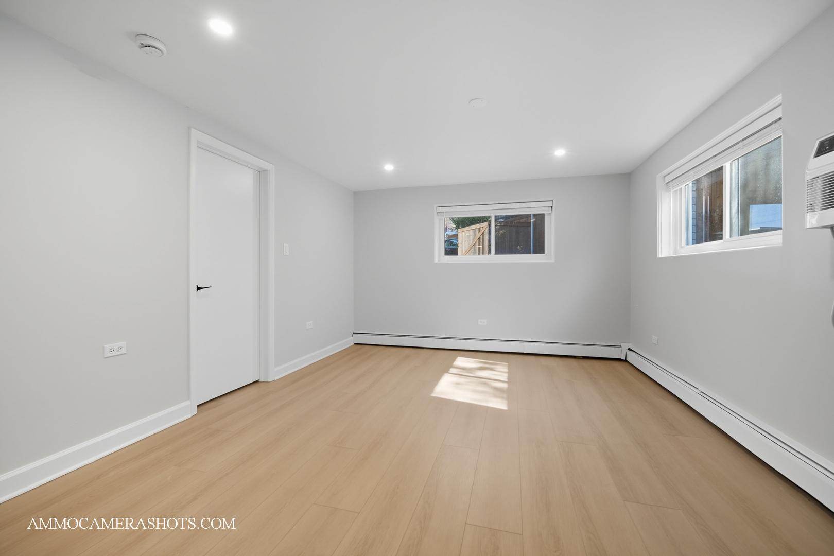 143 Ann Street, Unit 1S Clarendon Hills, IL 60514 - Photo 5 of 27 a view of an empty room with wooden floor and a window