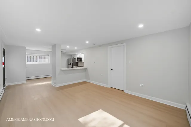 a view of an empty room with kitchen