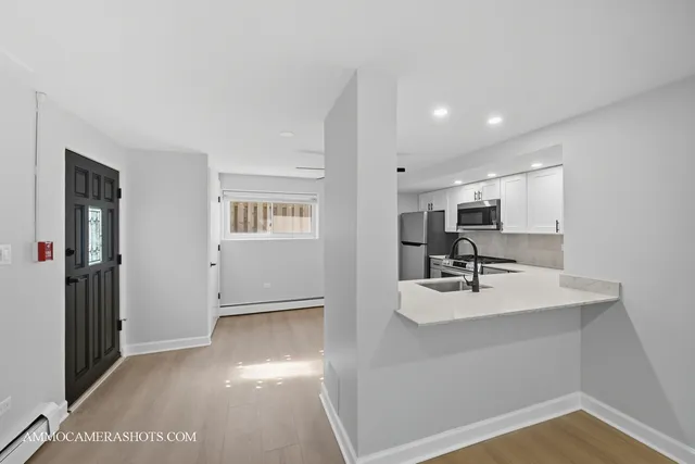 a view of kitchen with a sink storage and utility room