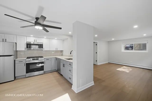 a kitchen with stainless steel appliances granite countertop cabinets and a refrigerator