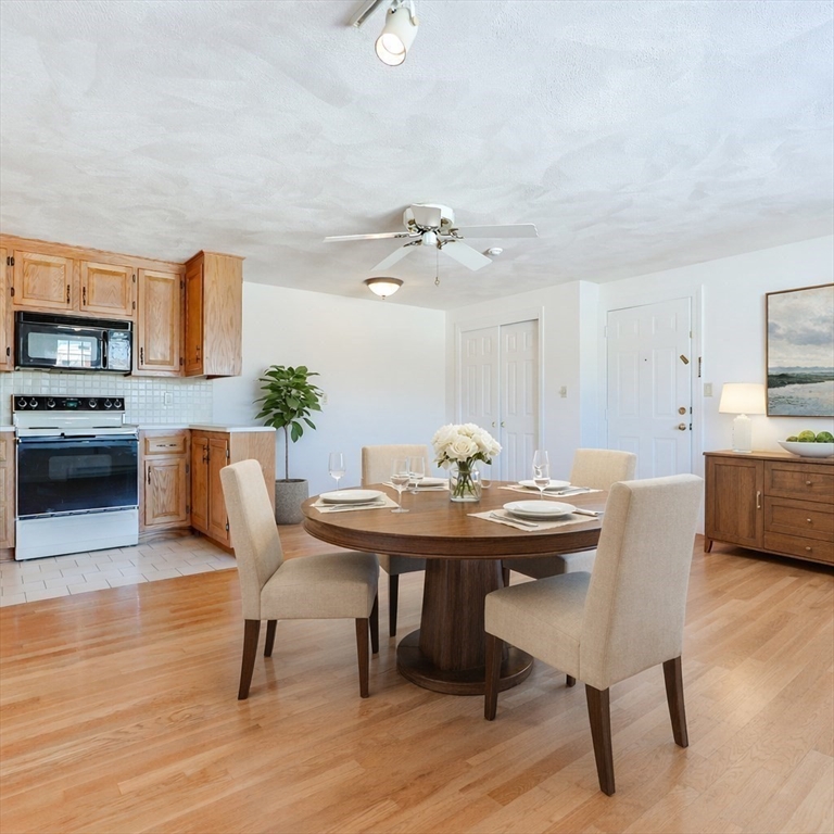 224 School Street, Unit 9 Walpole, MA 02081 - Photo 12 of 31 a view of a dining room with furniture and wooden floor