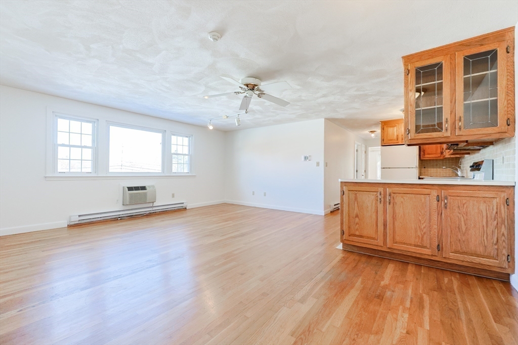 224 School Street, Unit 9 Walpole, MA 02081 - Photo 13 of 31 an empty room with wooden floor and windows