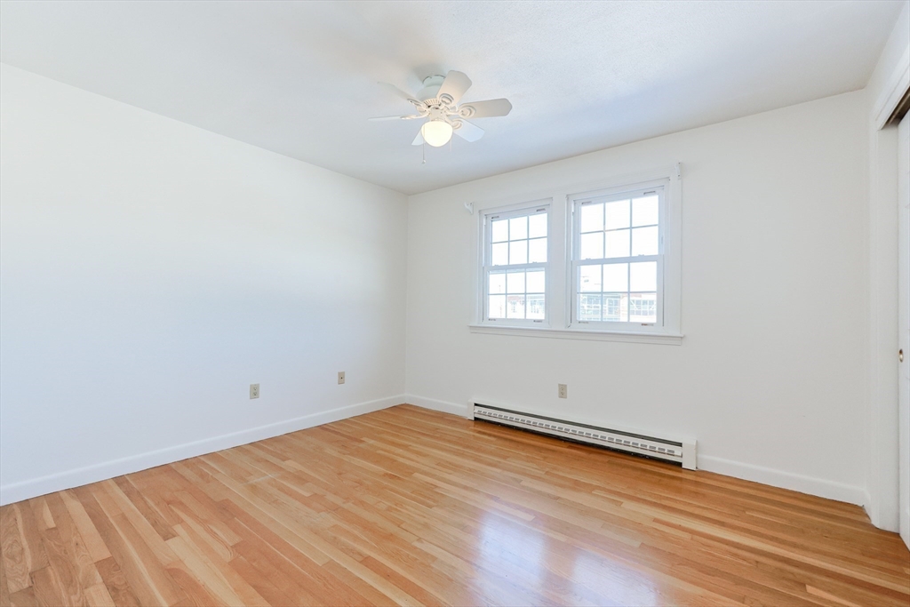224 School Street, Unit 9 Walpole, MA 02081 - Photo 15 of 31 an empty room with wooden floor and windows