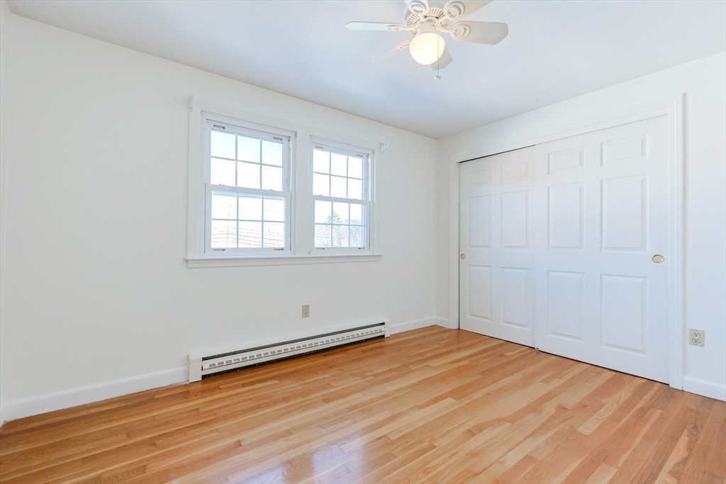 224 School Street, Unit 9 Walpole, MA 02081 - Photo 16 of 31 an empty room with wooden floor and windows