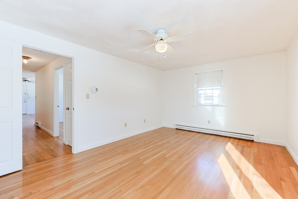 224 School Street, Unit 9 Walpole, MA 02081 - Photo 24 of 31 a view of an empty room with wooden floor and a window