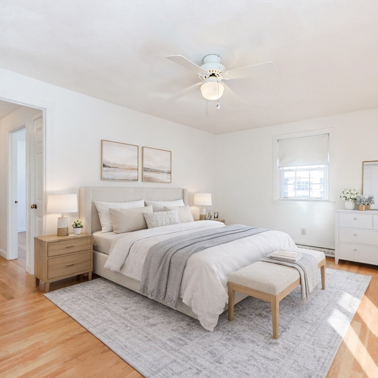 224 School Street, Unit 9 Walpole, MA 02081 - Photo 25 of 31 a bedroom with a bed and a chandelier