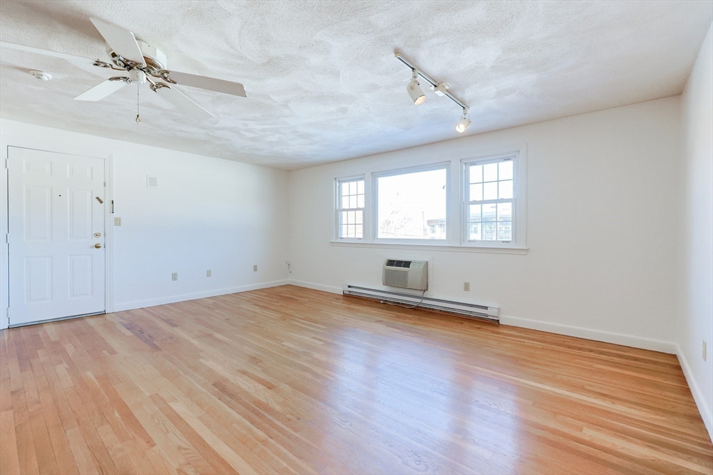 224 School Street, Unit 9 Walpole, MA 02081 - Photo 6 of 31 wooden floor in an empty room with a window