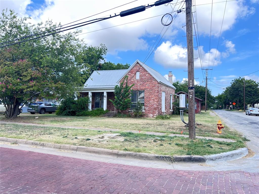 Attractive house on a nice corner lot facing a quaint brick laid street.