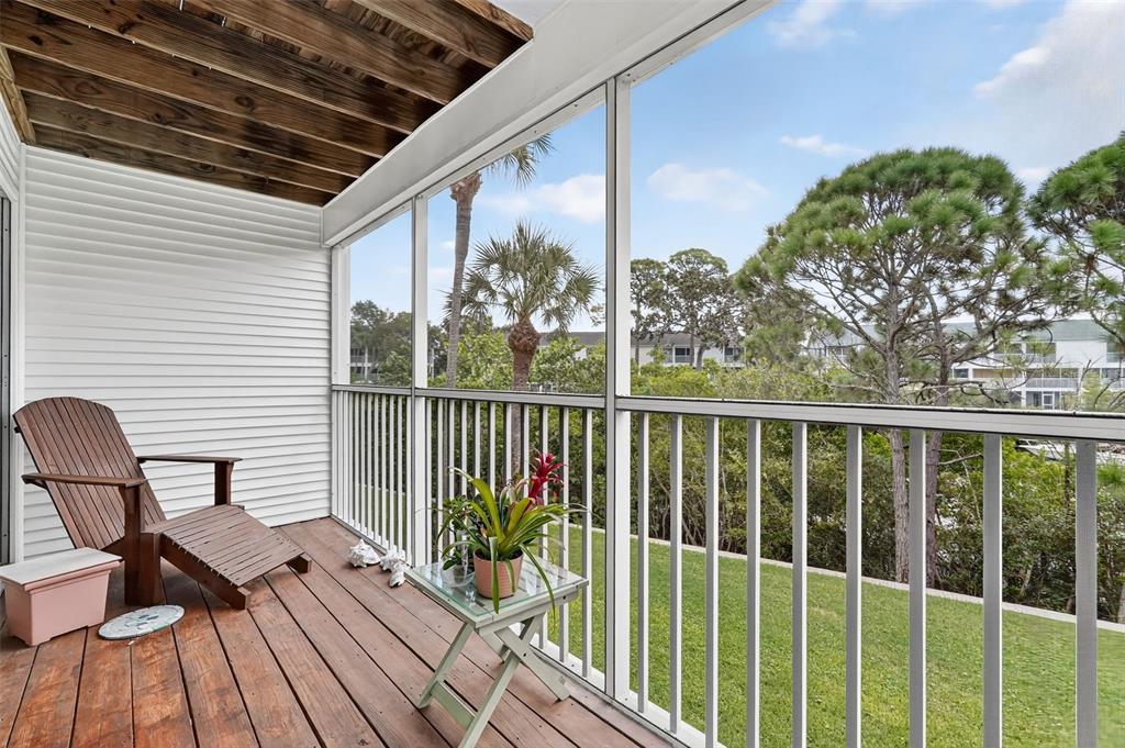 14879 Seminole Trail Seminole, FL 33776 - Photo 14 of 40 a balcony with wooden floor table and chairs