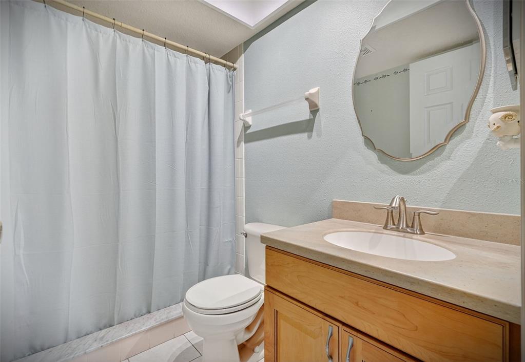 14879 Seminole Trail Seminole, FL 33776 - Photo 17 of 40 a bathroom with a sink a toilet and a mirror