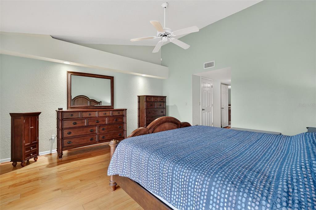 14879 Seminole Trail Seminole, FL 33776 - Photo 20 of 40 a bedroom with a bed and a dresser