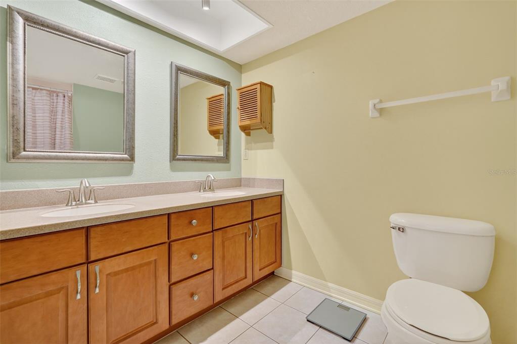 14879 Seminole Trail Seminole, FL 33776 - Photo 22 of 40 a bathroom with a toilet a sink and mirror