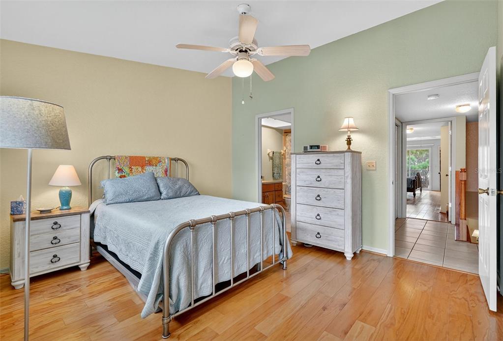 14879 Seminole Trail Seminole, FL 33776 - Photo 26 of 40 a bedroom with a bed and a chandelier