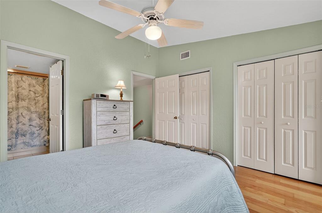 14879 Seminole Trail Seminole, FL 33776 - Photo 27 of 40 a bedroom with a bed and a chandelier