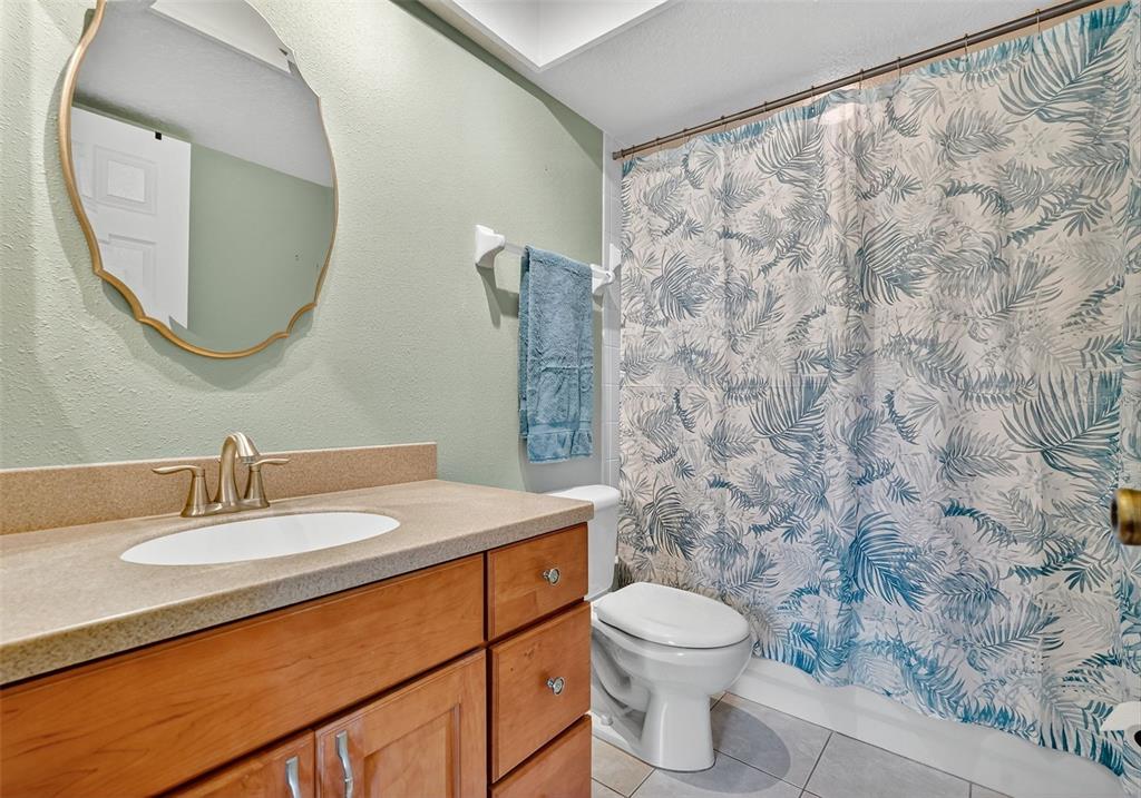 14879 Seminole Trail Seminole, FL 33776 - Photo 28 of 40 a bathroom with a sink a toilet and a mirror