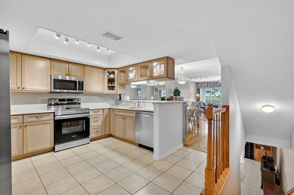 14879 Seminole Trail Seminole, FL 33776 - Photo 3 of 40 a kitchen with stainless steel appliances granite countertop a refrigerator and a stove top oven