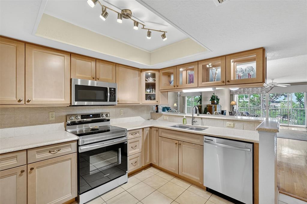 14879 Seminole Trail Seminole, FL 33776 - Photo 6 of 40 a kitchen with white cabinets and appliances