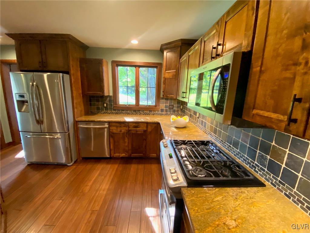 1665 Easton Road Hellertown, PA 18055 - Photo 12 of 37 a kitchen with stainless steel appliances granite countertop a stove a sink and a refrigerator