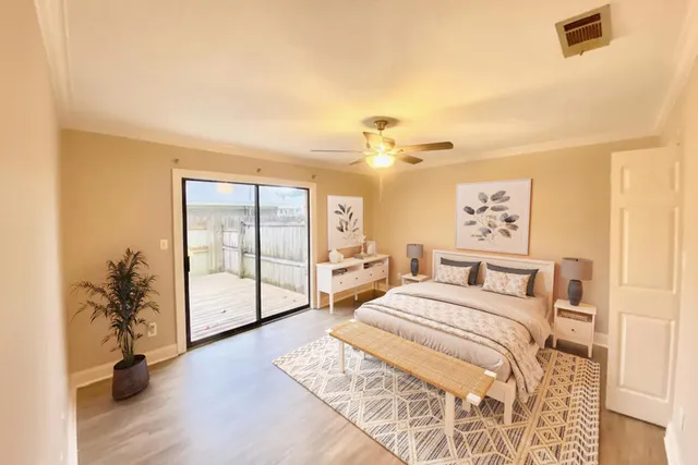 a spacious bedroom with a bed and a chandelier