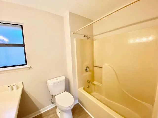 a bathroom with a toilet and a shower