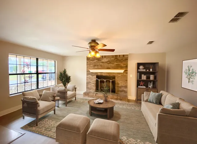 a living room with furniture and a fireplace