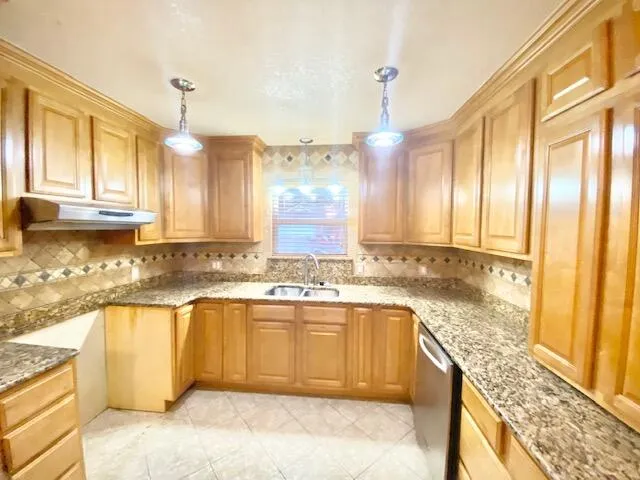 a large kitchen with a sink and cabinets