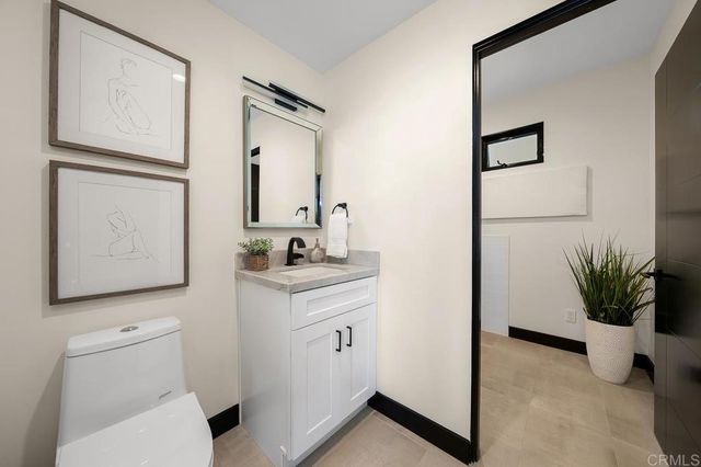 a bathroom with a toilet a sink and a mirror