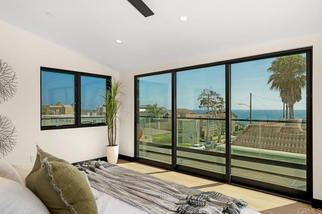 a view of a bedroom with furniture and window