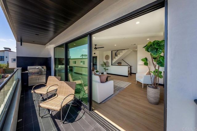 a view of a dining room with furniture a livingroom and chandelier