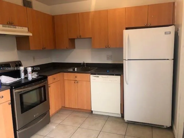 a white refrigerator freezer sitting inside of a kitchen