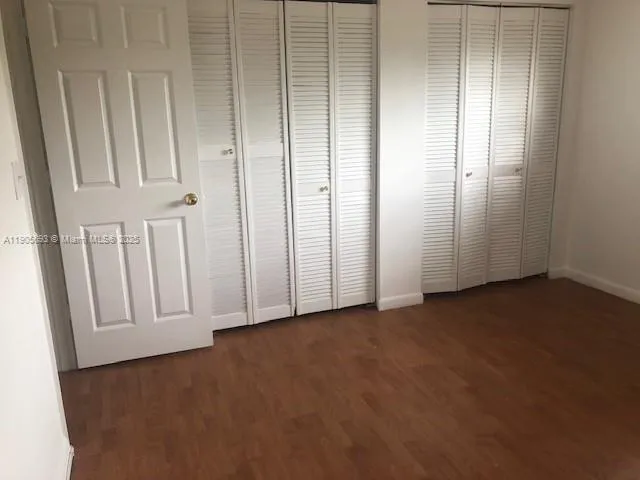 an empty room with wooden floor