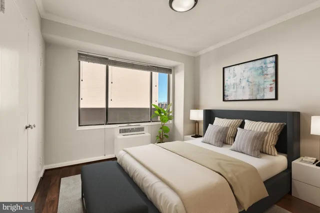 a bedroom with a bed and a large window