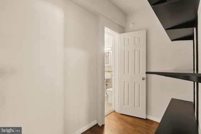 a view of a hallway with wooden floor